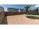 Backyard featuring a trampoline, partial palm tree, and privacy wall at 7077 Sunland Hills Ave, Las Vegas, NV 89113