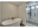 Bright bathroom featuring a soaking tub, glass shower, and modern fixtures at 7077 Sunland Hills Ave, Las Vegas, NV 89113