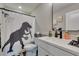 bathroom with fun dinosaur-themed shower curtain, neutral decor, and modern fixtures at 7077 Sunland Hills Ave, Las Vegas, NV 89113