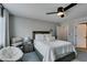 This cozy bedroom features a ceiling fan, comfortable chair, and a stylish nightstand at 7077 Sunland Hills Ave, Las Vegas, NV 89113