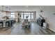 Eat-in kitchen and dining area with stainless steel appliances, modern lighting, and barstool seating at 7077 Sunland Hills Ave, Las Vegas, NV 89113