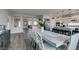 Open-concept dining area featuring a large table with seating for eight, flowing into a modern kitchen at 7077 Sunland Hills Ave, Las Vegas, NV 89113
