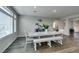 Open dining room with a long table, bright windows, and direct access to the staircase at 7077 Sunland Hills Ave, Las Vegas, NV 89113