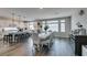 Eat-in kitchen and dining area with stainless steel appliances, modern lighting, and barstool seating at 7077 Sunland Hills Ave, Las Vegas, NV 89113