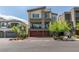 Contemporary two-story home featuring a stone facade accent, balcony, and two-car garage at 7077 Sunland Hills Ave, Las Vegas, NV 89113