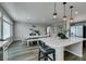 Open kitchen area, showcasing dining table and connecting to the kitchen island with bar stool seating at 7077 Sunland Hills Ave, Las Vegas, NV 89113