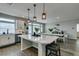 Open kitchen showcasing an island with seating, stainless steel appliances, and a view into the dining area at 7077 Sunland Hills Ave, Las Vegas, NV 89113