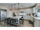 Well-appointed kitchen featuring an island with barstool seating, stainless steel appliances, and white cabinetry at 7077 Sunland Hills Ave, Las Vegas, NV 89113