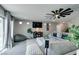 Bright living room with an extra large sectional, modern fan, and decor at 7077 Sunland Hills Ave, Las Vegas, NV 89113