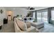 Large, inviting living room featuring plush seating, neutral decor, and sliding glass doors to the backyard at 7077 Sunland Hills Ave, Las Vegas, NV 89113