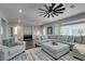 Bright living room featuring wood floors, a large sectional, area rug, and plenty of natural light at 7077 Sunland Hills Ave, Las Vegas, NV 89113