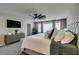 Inviting primary bedroom featuring a TV, modern decor, and comfortable, stylish furnishings at 7077 Sunland Hills Ave, Las Vegas, NV 89113