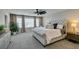 Serene primary bedroom with tufted headboard, neutral tones, and abundant natural light at 7077 Sunland Hills Ave, Las Vegas, NV 89113