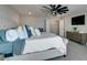 Elegant primary bedroom with neutral decor, plush bedding, and an adjoining bathroom at 7077 Sunland Hills Ave, Las Vegas, NV 89113