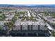 An aerial view showcases the surrounding community with manicured landscaping and beautiful mountain views at 7143 S Durango Dr # 202, Las Vegas, NV 89113