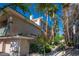 Charming condo exterior featuring well-maintained landscaping and a private garage in a vibrant community at 7143 S Durango Dr # 202, Las Vegas, NV 89113