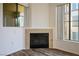 Close up on a fireplace in the living room with wood-look floors and natural lighting at 7143 S Durango Dr # 202, Las Vegas, NV 89113