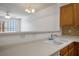 Bright kitchen with a double sink and view to the adjacent living area for a spacious and connected living experience at 7143 S Durango Dr # 202, Las Vegas, NV 89113