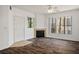 Bright living room featuring wood-look floors, a cozy fireplace, and large windows at 7143 S Durango Dr # 202, Las Vegas, NV 89113