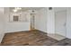 Spacious living room with modern wood-look floors and access to other rooms at 7143 S Durango Dr # 202, Las Vegas, NV 89113