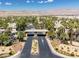 Street view features the community entrance, showcasing beautiful landscaping and a well-maintained roadway at 7143 S Durango Dr # 202, Las Vegas, NV 89113
