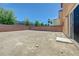 View of the spacious backyard featuring block wall, side yard, and sliding door entry at 7464 Edgecove Ct, Las Vegas, NV 89139