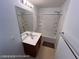 Bathroom featuring a single sink vanity, shower over tub and neutral finishes at 7464 Edgecove Ct, Las Vegas, NV 89139