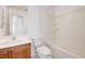 Well-lit bathroom with a white sink, toilet, and shower-tub combination at 7464 Edgecove Ct, Las Vegas, NV 89139