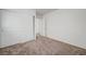 Clean bedroom with neutral carpet and a closet featuring sliding doors, offering ample storage at 7464 Edgecove Ct, Las Vegas, NV 89139
