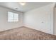 Carpeted bedroom with a window, neutral walls, and bright natural light at 7464 Edgecove Ct, Las Vegas, NV 89139