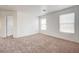 Bedroom showcasing plush carpeting, two windows, and ample natural light at 7464 Edgecove Ct, Las Vegas, NV 89139