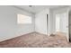 Cozy bedroom with neutral carpet, closet with white doors, and window for natural light at 7464 Edgecove Ct, Las Vegas, NV 89139