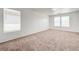 Bright bedroom featuring plush carpeting, neutral walls, and multiple windows for ample natural light at 7464 Edgecove Ct, Las Vegas, NV 89139