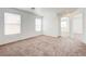 Bright bedroom featuring neutral carpet, white walls, and windows providing natural light at 7464 Edgecove Ct, Las Vegas, NV 89139