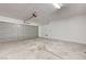 Spacious two-car garage featuring a concrete floor and a gray garage door at 7464 Edgecove Ct, Las Vegas, NV 89139