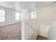 A hallway showcasing neutral carpet, white walls, and a staircase with a white handrail at 7464 Edgecove Ct, Las Vegas, NV 89139