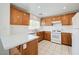 Spacious kitchen featuring wood cabinets, white appliances, and ample countertop space, perfect for meal preparation and entertaining at 7464 Edgecove Ct, Las Vegas, NV 89139