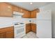 Bright kitchen with wood cabinets, white appliances, and a gas range stove, perfect for cooking enthusiasts at 7464 Edgecove Ct, Las Vegas, NV 89139