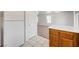 Open kitchen area with wood cabinets, tiled flooring, and a view into the adjacent living space, creating a connected feel at 7464 Edgecove Ct, Las Vegas, NV 89139