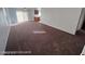 Spacious carpeted living room offering versatility for various furniture arrangements at 7464 Edgecove Ct, Las Vegas, NV 89139