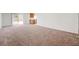 Expansive carpeted living room showing access to the kitchen and bright views, perfect for entertaining and Gathering gatherings at 7464 Edgecove Ct, Las Vegas, NV 89139