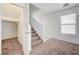 View of the staircase with neutral carpet, white walls, and an open view of the home's interior at 7464 Edgecove Ct, Las Vegas, NV 89139