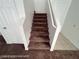 Carpeted stairway with white handrails provides access to upper levels of the home at 7464 Edgecove Ct, Las Vegas, NV 89139