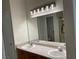 Bathroom vanity with double sinks and modern lighting at 7620 Donald Nelson Ave, Las Vegas, NV 89131