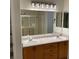 Bathroom featuring a double vanity with modern lighting fixtures at 7620 Donald Nelson Ave, Las Vegas, NV 89131