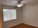 Simple bedroom features a ceiling fan and a window at 7620 Donald Nelson Ave, Las Vegas, NV 89131