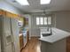Bright kitchen features wooden cabinets, white appliances, and a breakfast bar at 7620 Donald Nelson Ave, Las Vegas, NV 89131