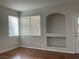 Inviting living room with ample natural light, hardwood floors, and built-in shelving, ready for personal touches at 7620 Donald Nelson Ave, Las Vegas, NV 89131