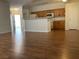 Open-concept living room with hardwood floors, breakfast bar, and modern lighting perfect for entertaining at 7620 Donald Nelson Ave, Las Vegas, NV 89131