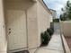 Charming side entrance with a white door, landscaped walkway, and privacy gate, offering curb appeal at 7620 Donald Nelson Ave, Las Vegas, NV 89131